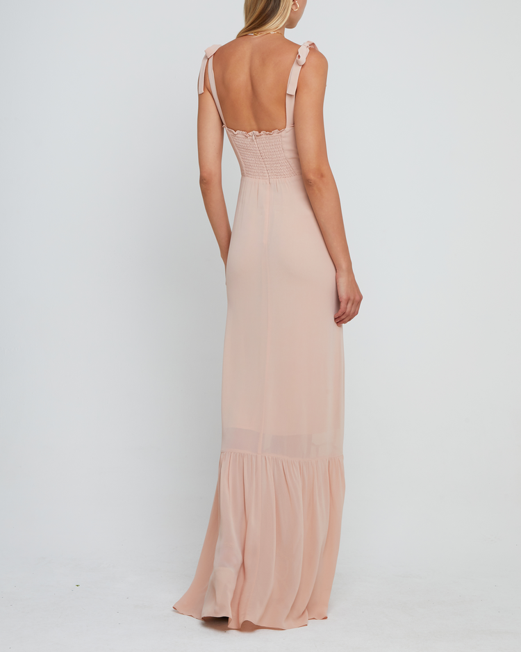 Second image of La Rue Dress, a pink floor-length bridesmaid dress with adjustable tie straps, cup detail, neckline ruffles, tiered skirt, lining, back smocking and back zipper