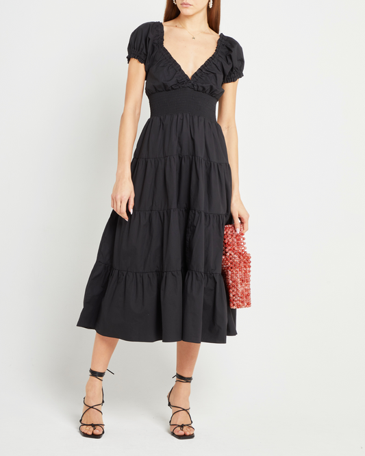 First image of Cotton Delia Dress, a black midi dress, V-neck, ruffle, cap sleeves, short sleeves, tiered