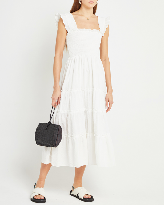 First image of Calypso Maxi Dress, a white maxi dress, swiss dot material, smocked bodice, ruffles cap sleeves 