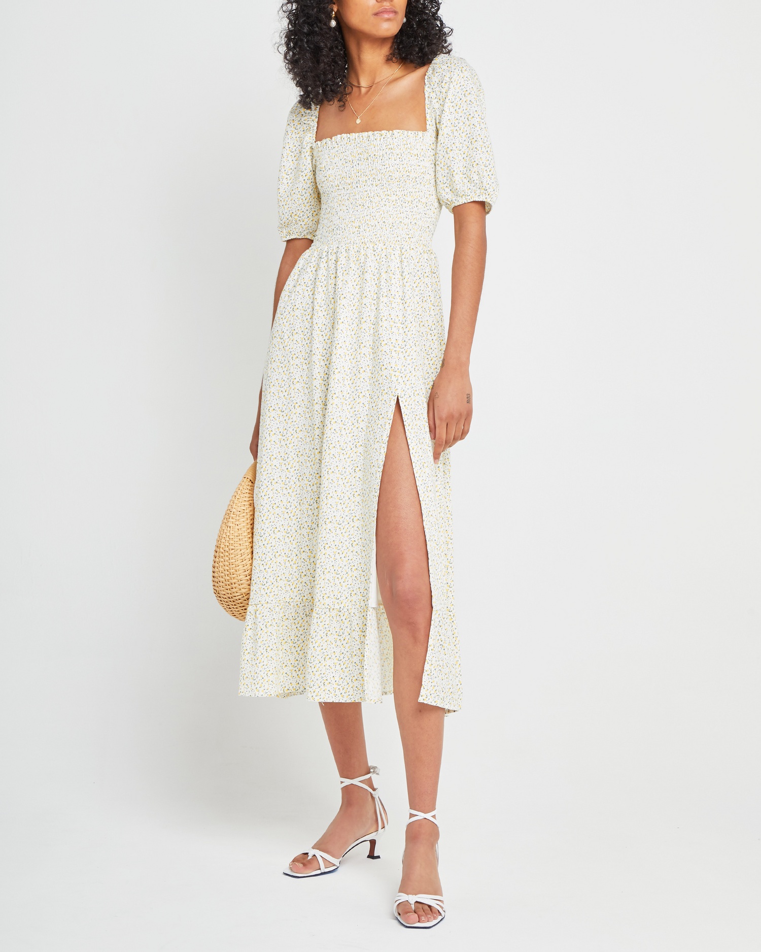 First image of Daisy Midi Dress, a yellow midi dress, side slit, smocked bodice, square neckline, puff sleeves