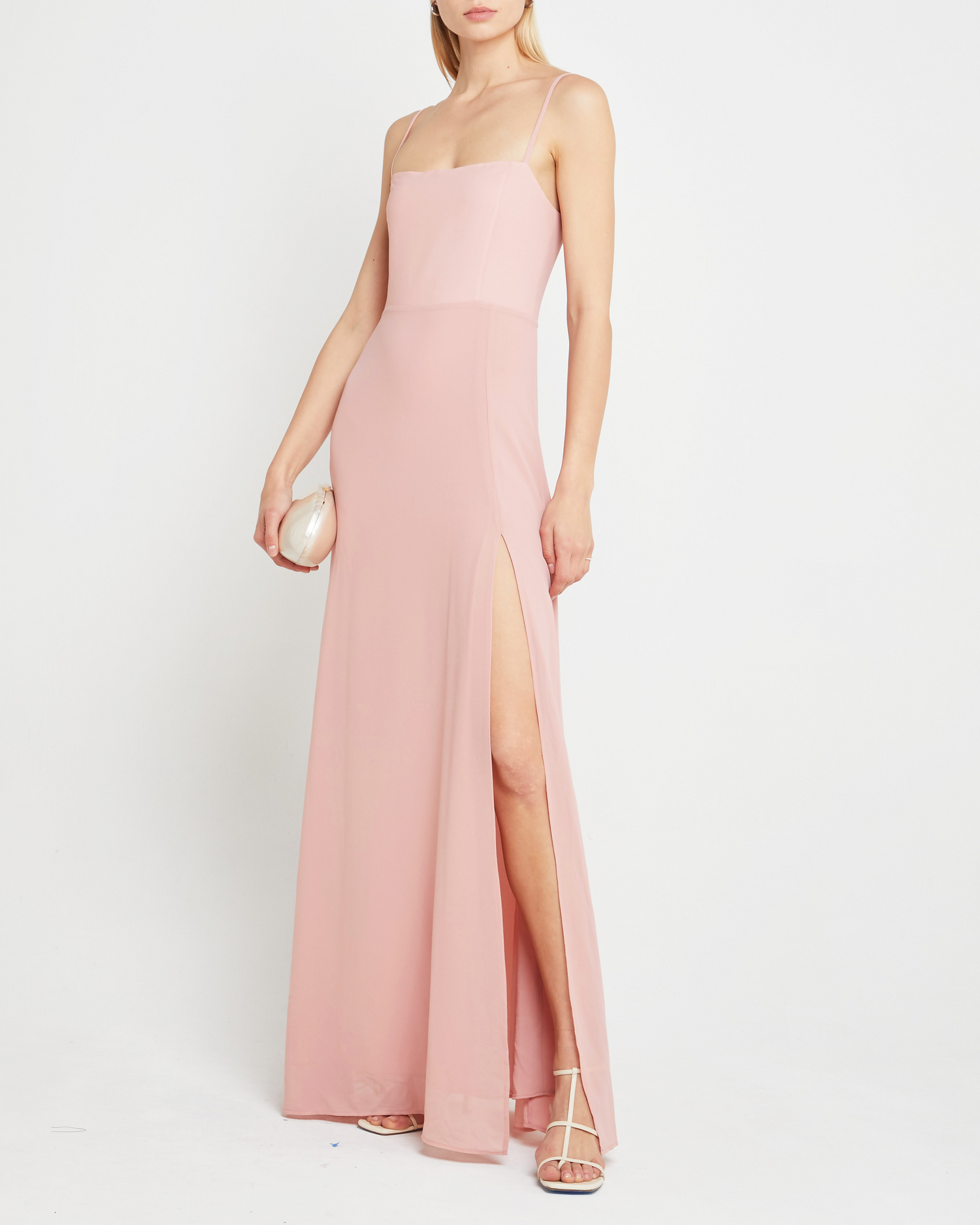 First image of Jessica Maxi Dress, a pink wedding guest dress with back zipper, straight neckline, side slit, adjustable straps, smocked back detail, and lining
