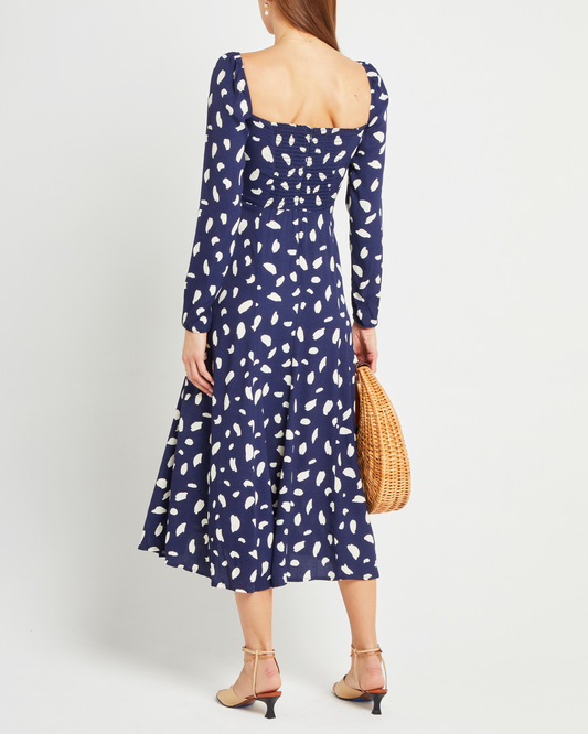 Second image of Lenon Dress, a midi dress, side skirt slit, long sleeves, square neckline, blue material with white irregular dots