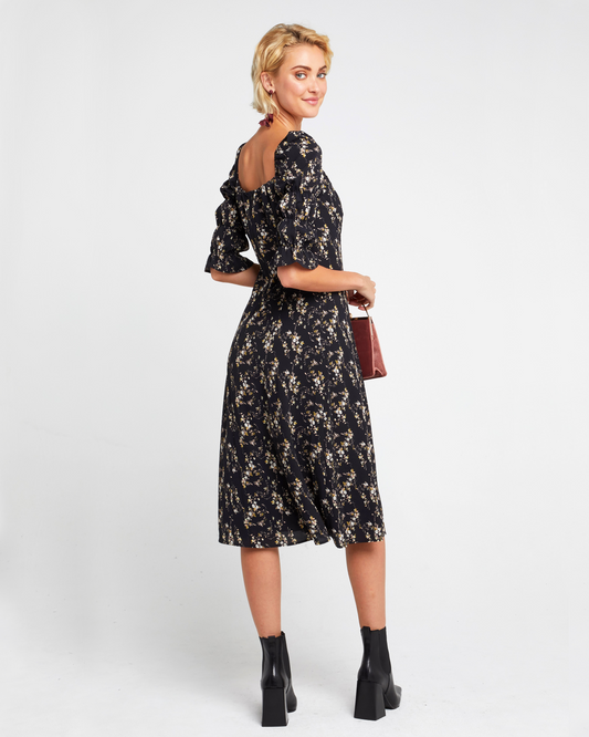 Second image of She's Picky Dress, a black midi dress, puff sleeves, 3/4 sleeves, fall, floral, side slit