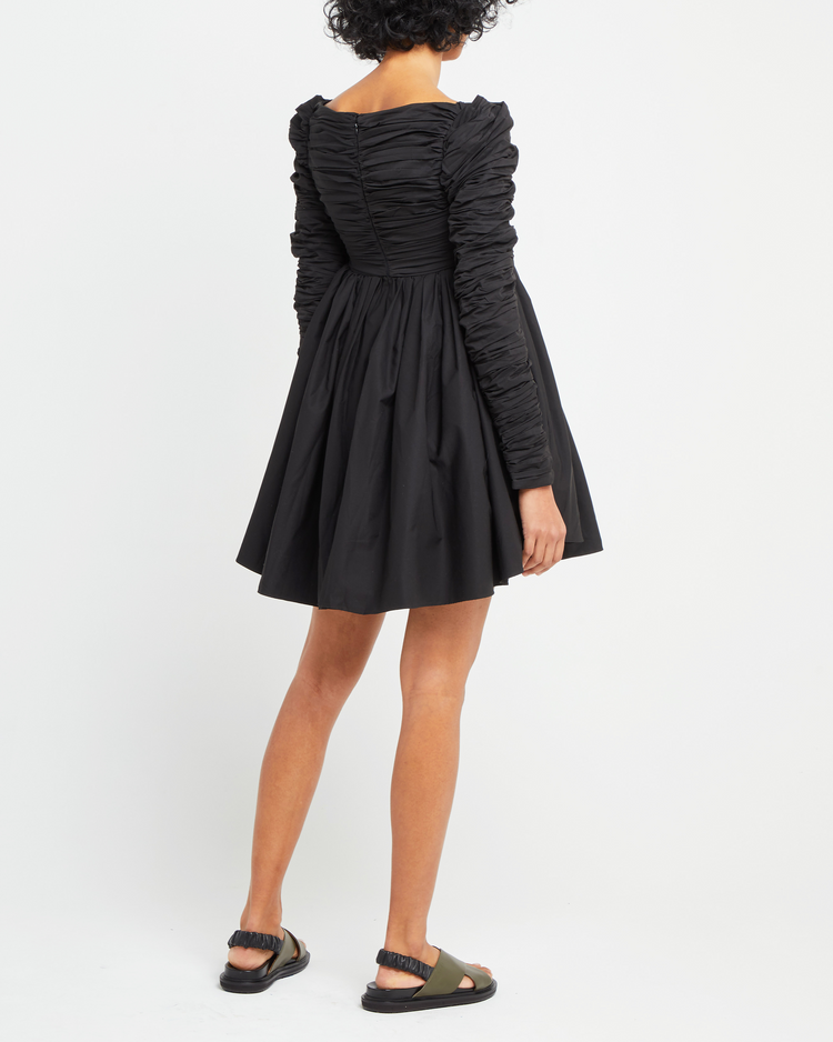 Second image of Structured Long-Sleeve Frock, a black mini dress, babydoll silhouette, long ruched sleeves, square neckline