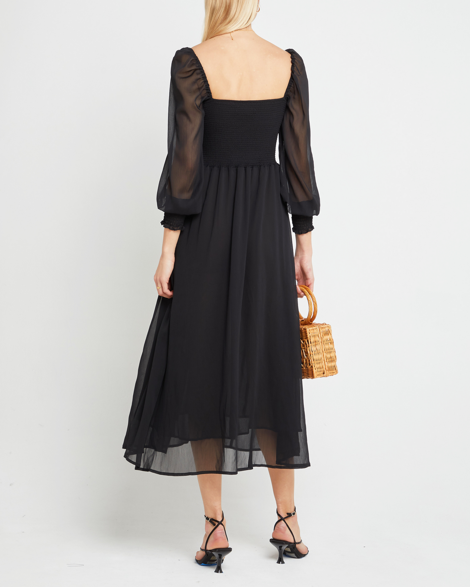 Second image of Classic Smocked Maxi Dress, a black maxi dress, side slit, long, sheer sleeves, puff sleeves, suqare neckline, smocke bodice