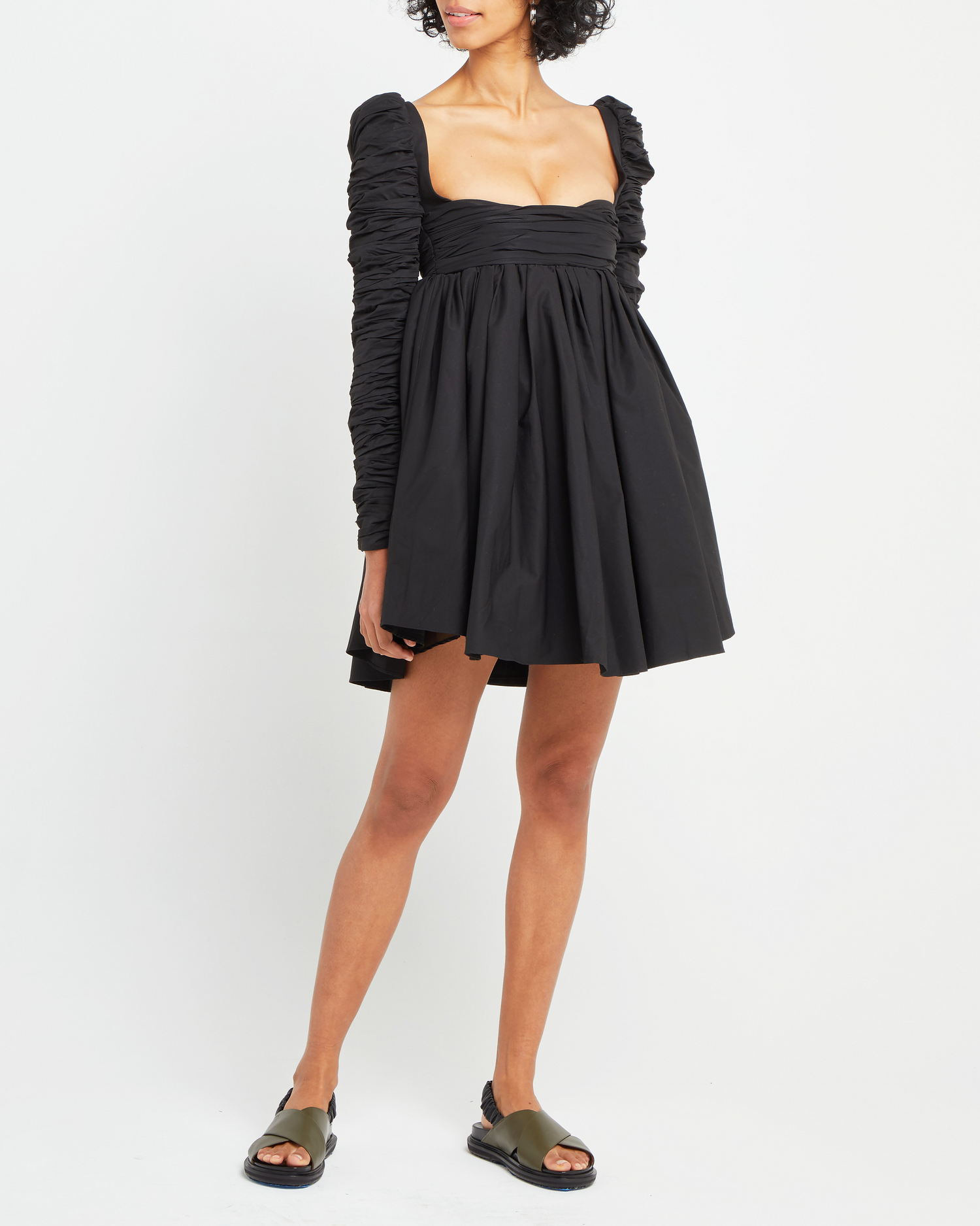 Fourth image of Structured Long-Sleeve Frock, a black mini dress, babydoll silhouette, long ruched sleeves, square neckline