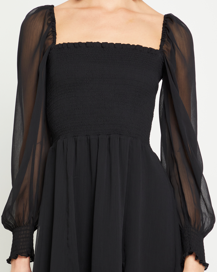 Sixth image of Classic Smocked Midi Dress, a black midi dress, side slit, long, sheer sleeves, puff sleeves, square neckline, smocked bodice