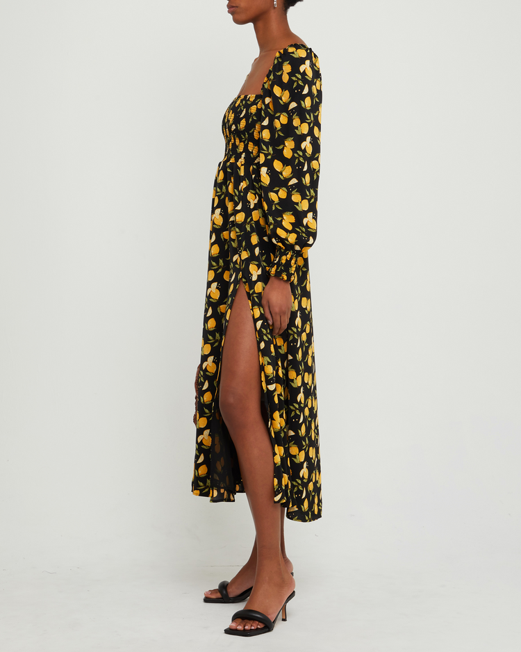 Fourth image of Classic Smocked Maxi Dress, a black maxi dress, side slit, long, sheer sleeves, puff sleeves, square neckline, smocked bodice, yellow lemon print