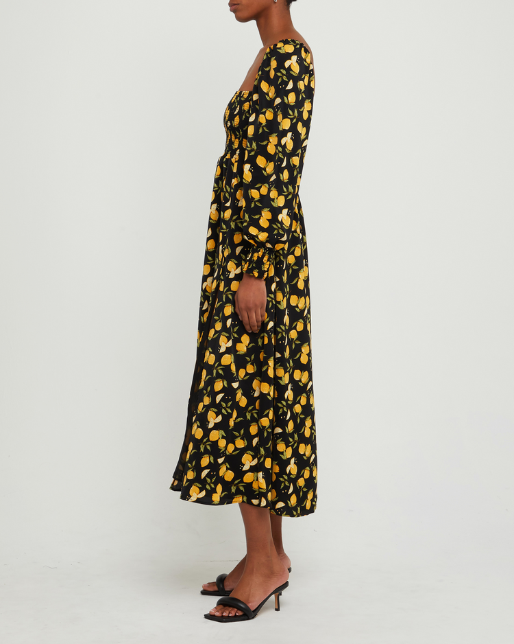 Fifth image of Classic Smocked Maxi Dress, a black maxi dress, side slit, long, sheer sleeves, puff sleeves, square neckline, smocked bodice, yellow lemon print