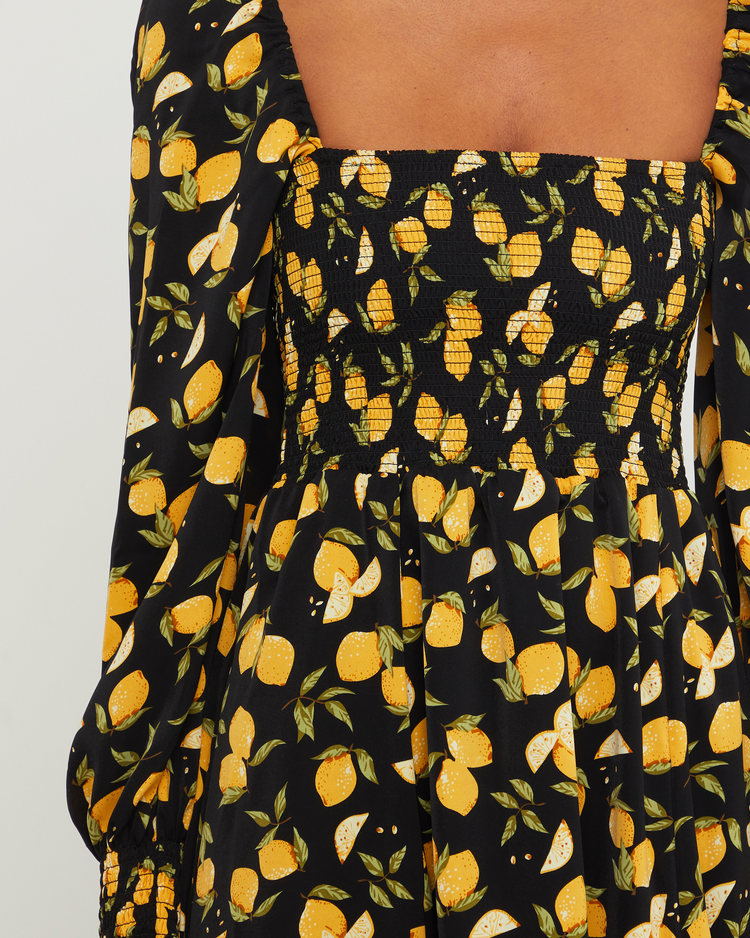 Sixth image of Classic Smocked Maxi Dress, a black maxi dress, side slit, long, sheer sleeves, puff sleeves, square neckline, smocked bodice, yellow lemon print