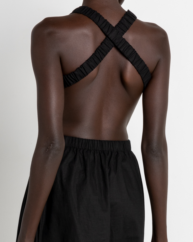Sixth image of Bandage Dress, a black midi dress, open back, elastic straps, high neckline