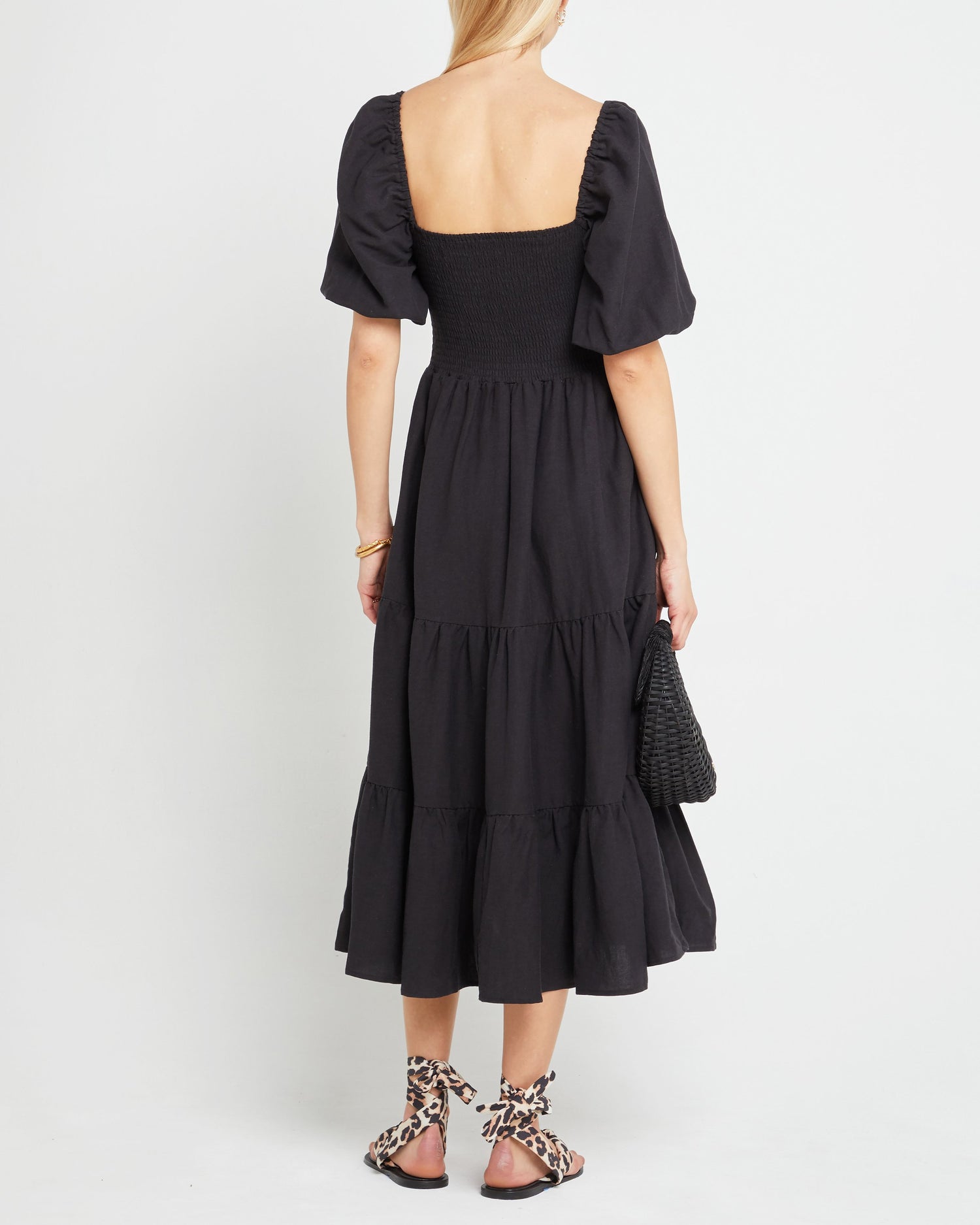 Second image of Hera Dress, a black midi dress, smocked, puff sleeves, cap sleeves