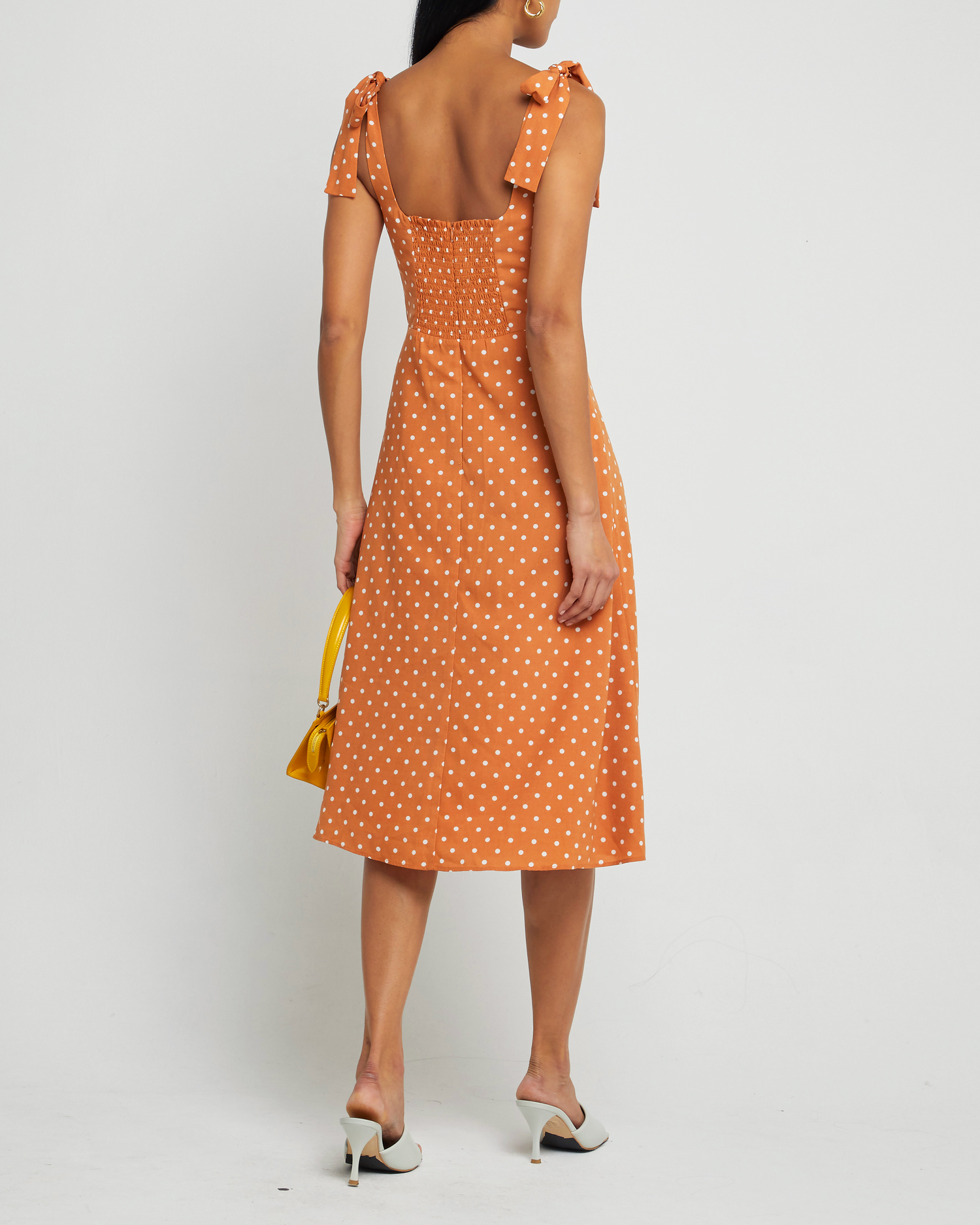 Second image of Sasha Dress, a orange midi dress, side slit, tie straps, bow, ribbon, polka dot