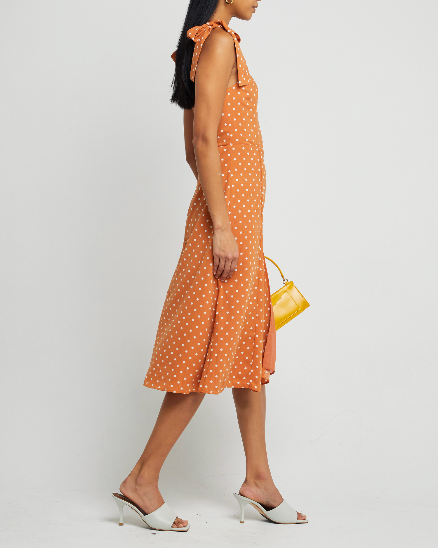 Third image of Sasha Dress, a orange midi dress, side slit, tie straps, bow, ribbon, polka dot
