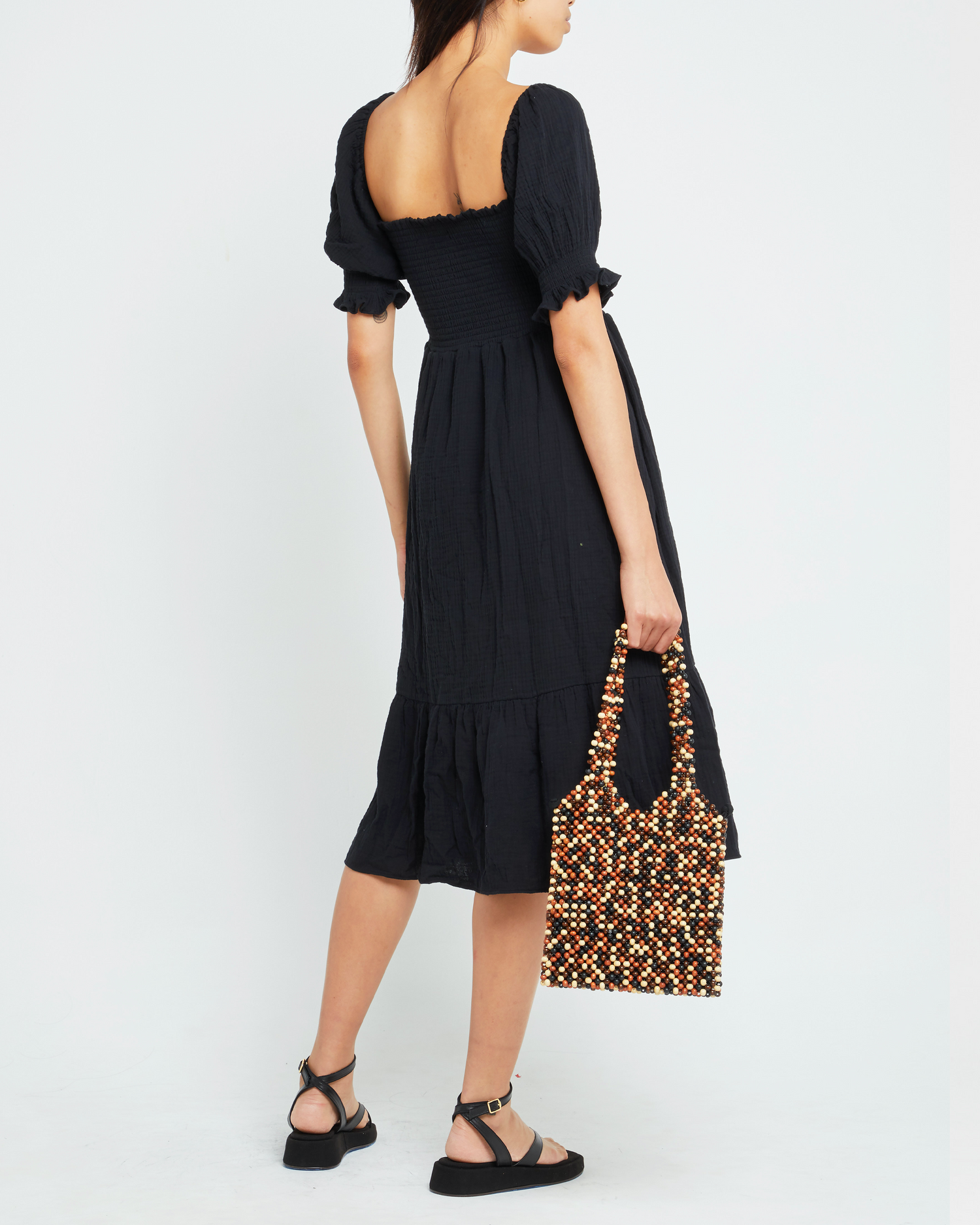 Second image of Angie Dress, a black midi dress, puff sleeves, smocked bodice, square neckline