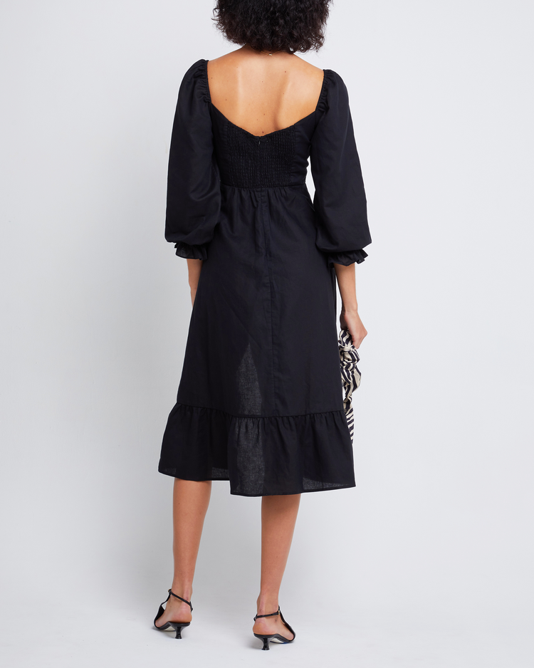 Fourth image of Aubrey Midi Dress, a black midi dress, long sleeves, puff sleeves, sweetheart neckline, side slit