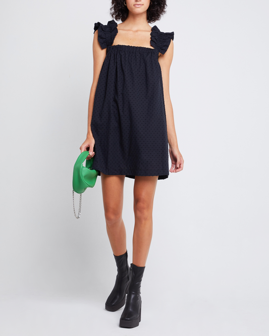 First image of Nivia Dress, a black mini dress, ruffle sleeves, cap sleeves, flowy, relaxed