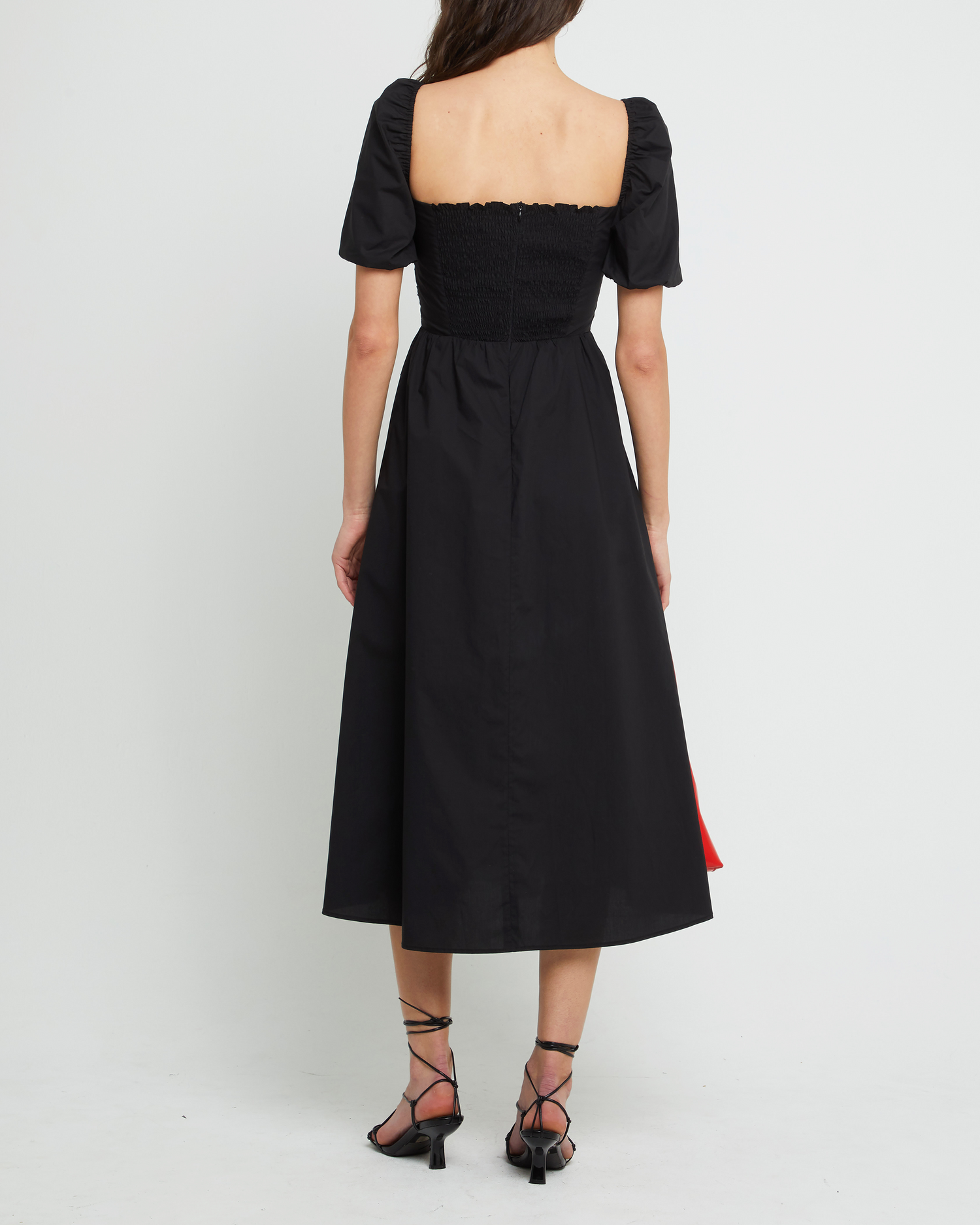 Second image of River Dress, a black midi dress, square neckline, short puff sleeves, gathered bodice