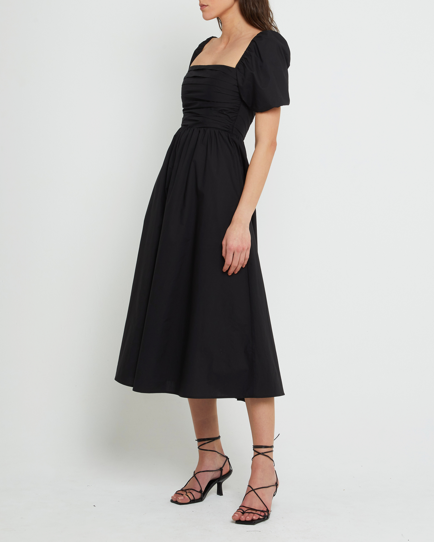 Third image of River Dress, a black midi dress, square neckline, short puff sleeves, gathered bodice