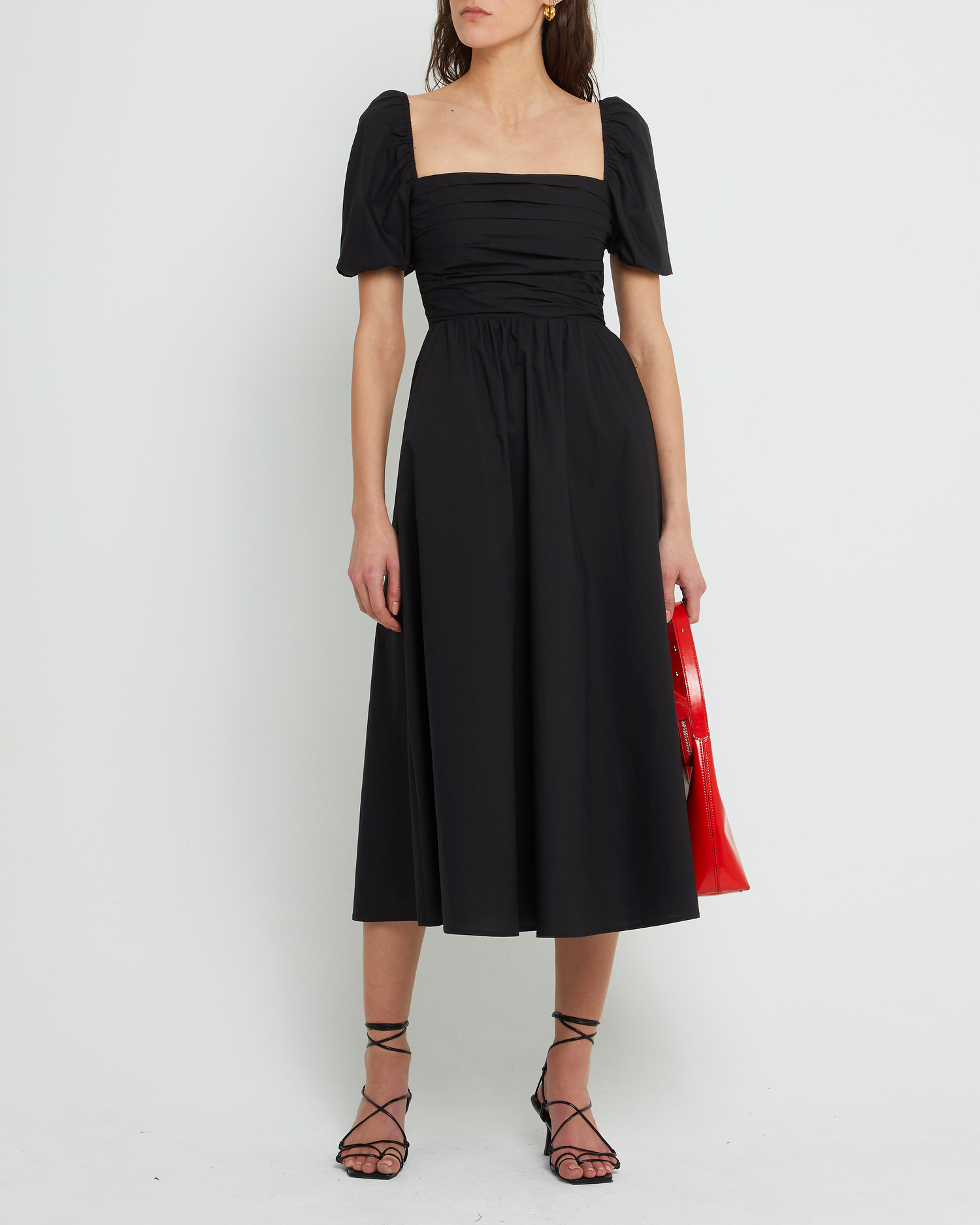 First image of River Dress, a black midi dress, square neckline, short puff sleeves, gathered bodice