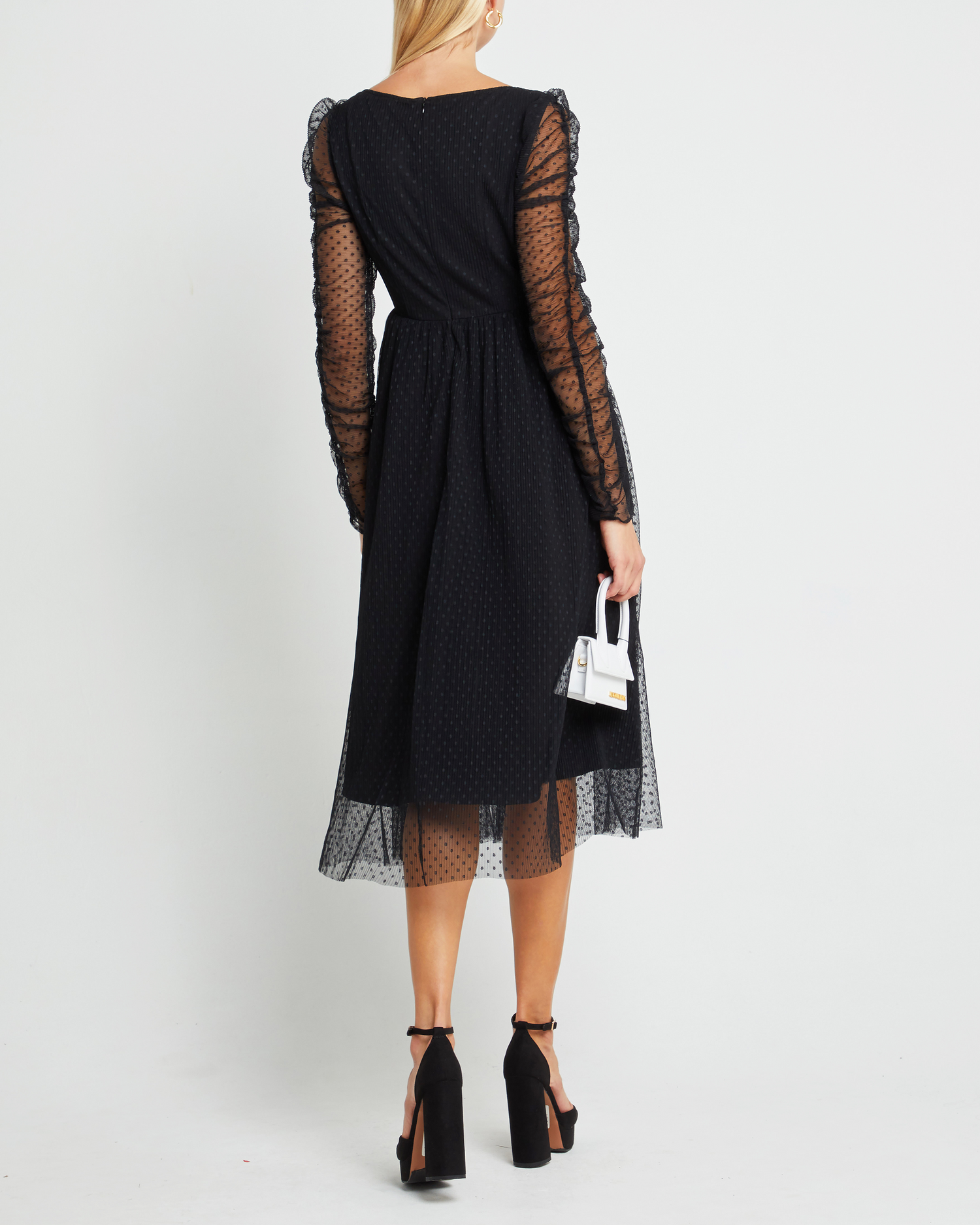 Second image of Daisy Dress, a black wedding guest dress with sheer long sleeves, v-neckline, ruched gathered bust detail, cinched waist, lining, dotted mesh fabric, and back zipper