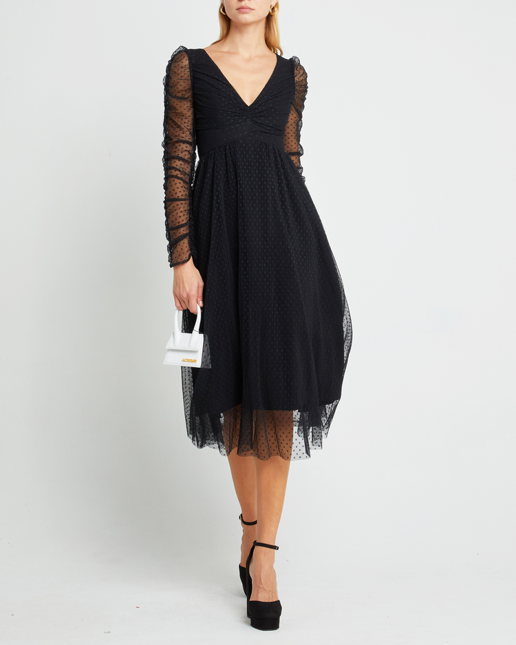 Fourth image of Daisy Dress, a black wedding guest dress with sheer long sleeves, v-neckline, ruched gathered bust detail, cinched waist, lining, dotted mesh fabric, and back zipper