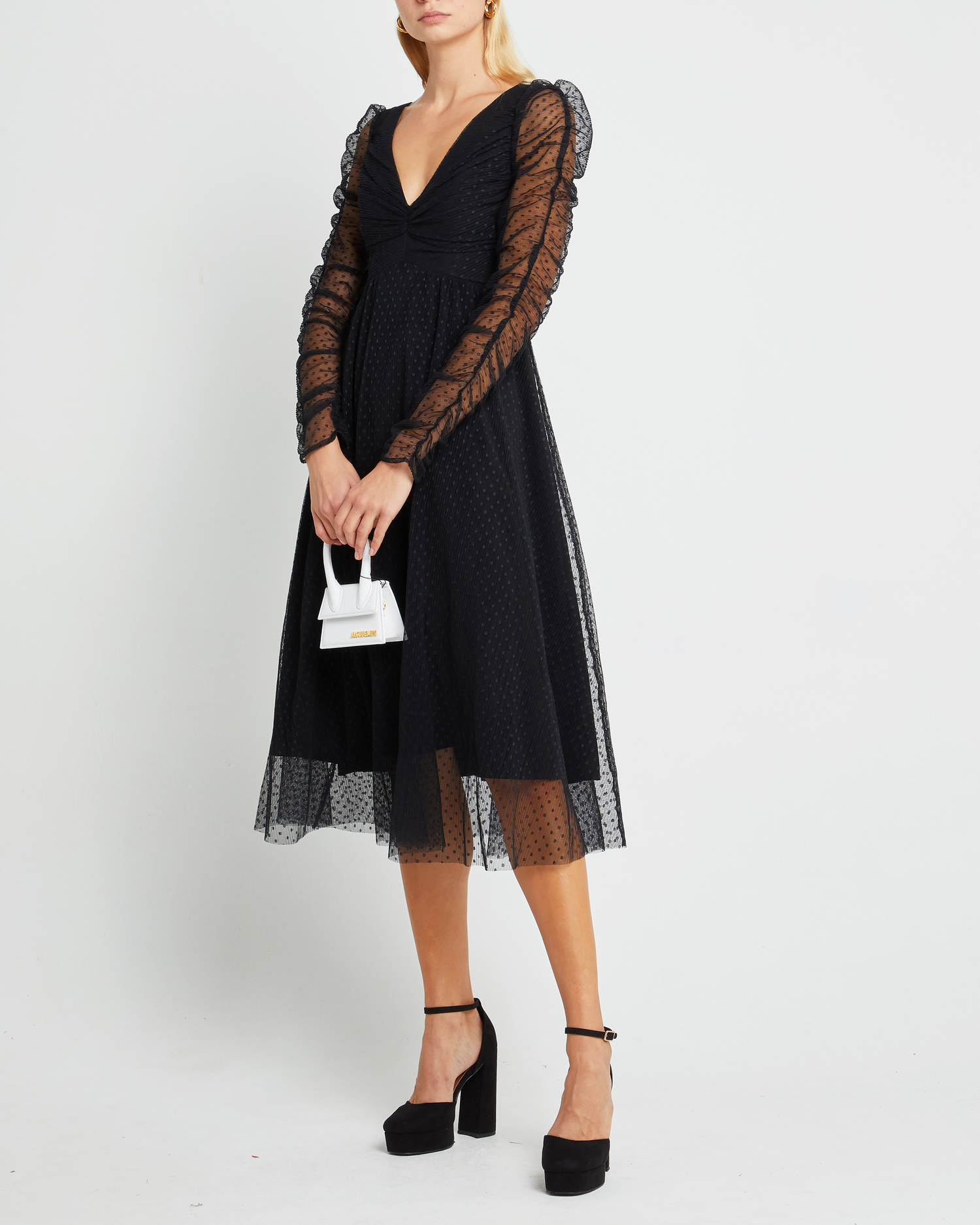 Fifth image of Daisy Dress, a black wedding guest dress with sheer long sleeves, v-neckline, ruched gathered bust detail, cinched waist, lining, dotted mesh fabric, and back zipper