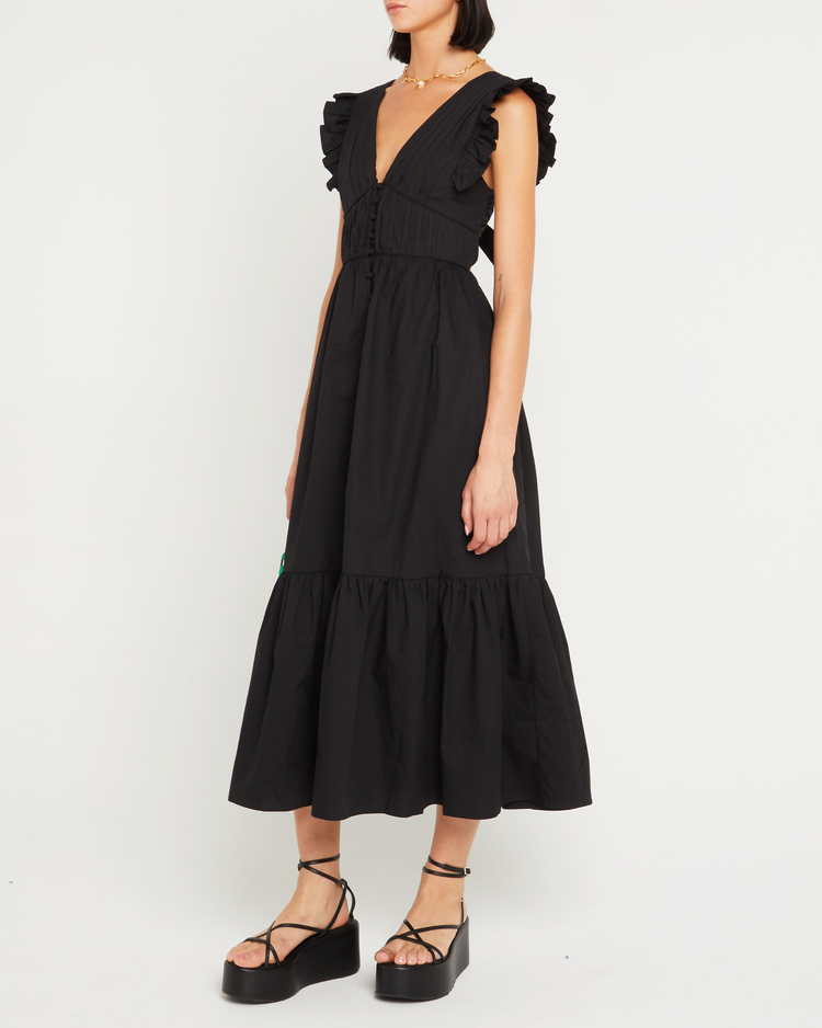 Third image of Stella Dress, a black midi dress, front buttons, ruffle sleeve, open back, tied ribbon, bow, tiered