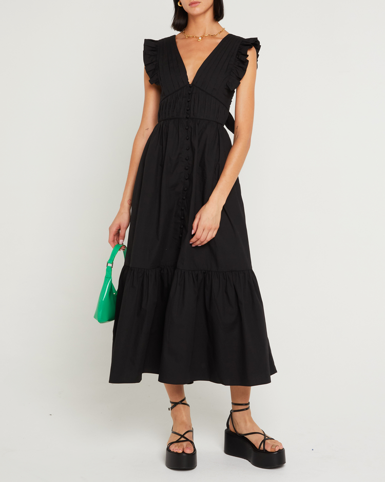 Fourth image of Stella Dress, a black midi dress, front buttons, ruffle sleeve, open back, tied ribbon, bow, tiered