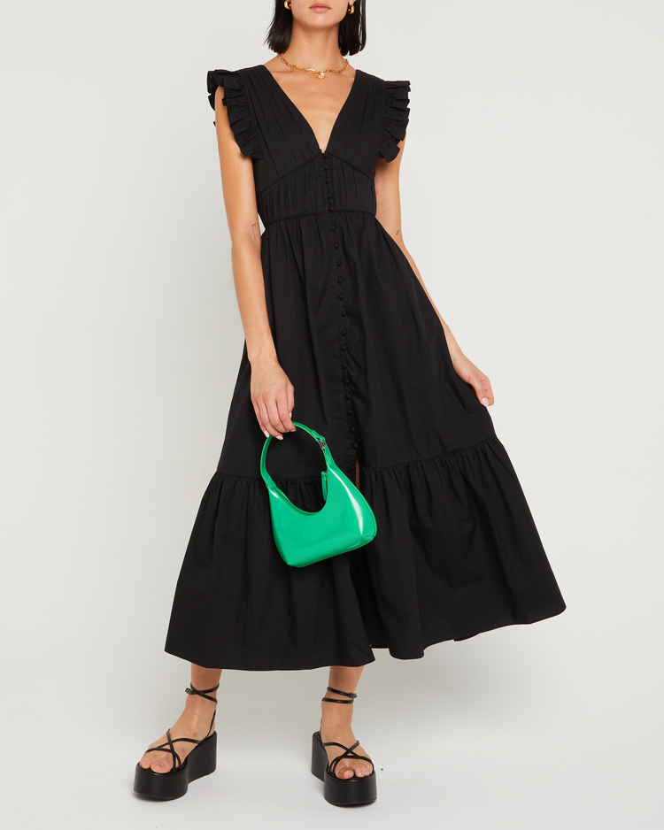 First image of Stella Dress, a black midi dress, front buttons, ruffle sleeve, open back, tied ribbon, bow, tiered