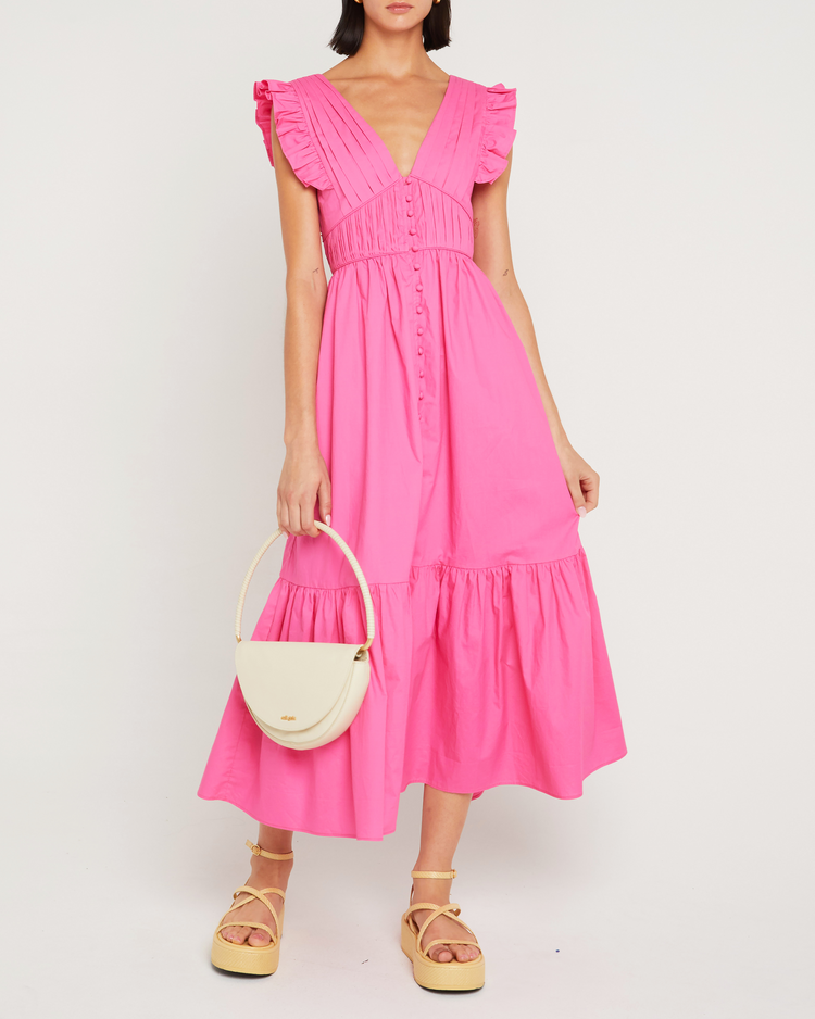 First image of Stella Dress, a pink midi dress, open back, front buttons, ribbon tie, bow, ruffle sleeves