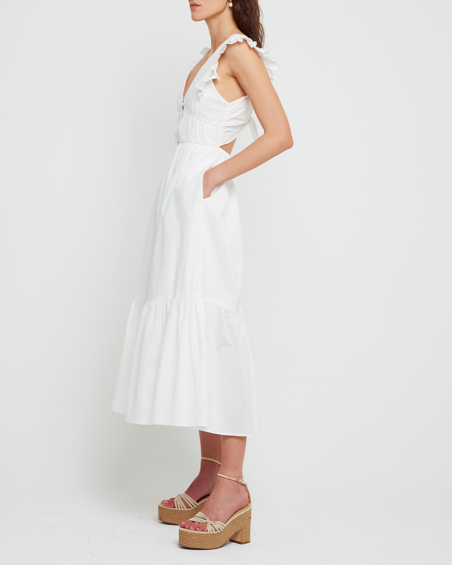 Third image of Stella Dress, a white midi dress, front buttons, ruffle sleeve, open back, tiered, tie, ribbon, bow