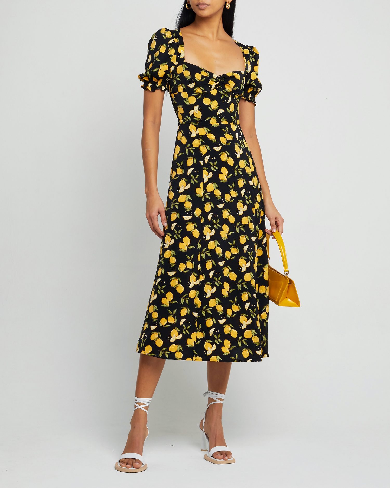 Fourth image of Melanie Dress, a black midi dress, side skirt slit, yellow lemon print, short sleeves, puff sleeves, cap sleeves, sweetheart neckline