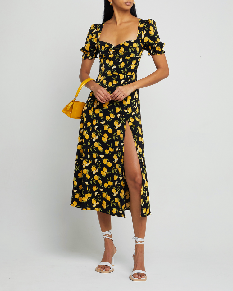 Fifth image of Melanie Dress, a black midi dress, side skirt slit, yellow lemon print, short sleeves, puff sleeves, cap sleeves, sweetheart neckline