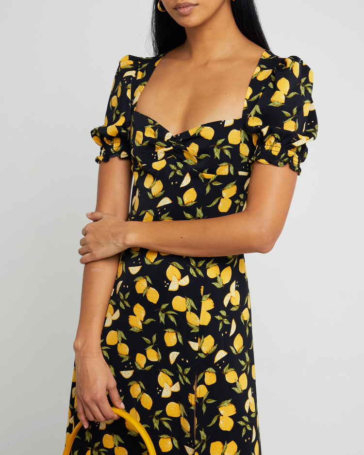 Sixth image of Melanie Dress, a black midi dress, side skirt slit, yellow lemon print, short sleeves, puff sleeves, cap sleeves, sweetheart neckline