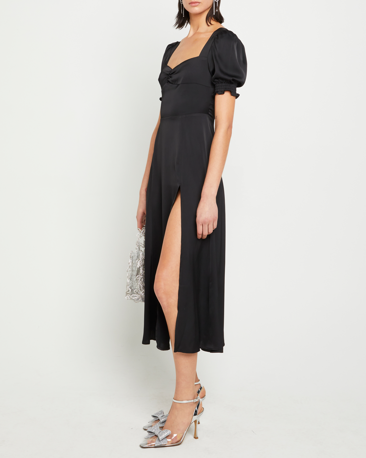 Third image of Melanie Dress, a black midi dress, side slit, silky, puff sleeve, cap sleeve, sweetheart neckline