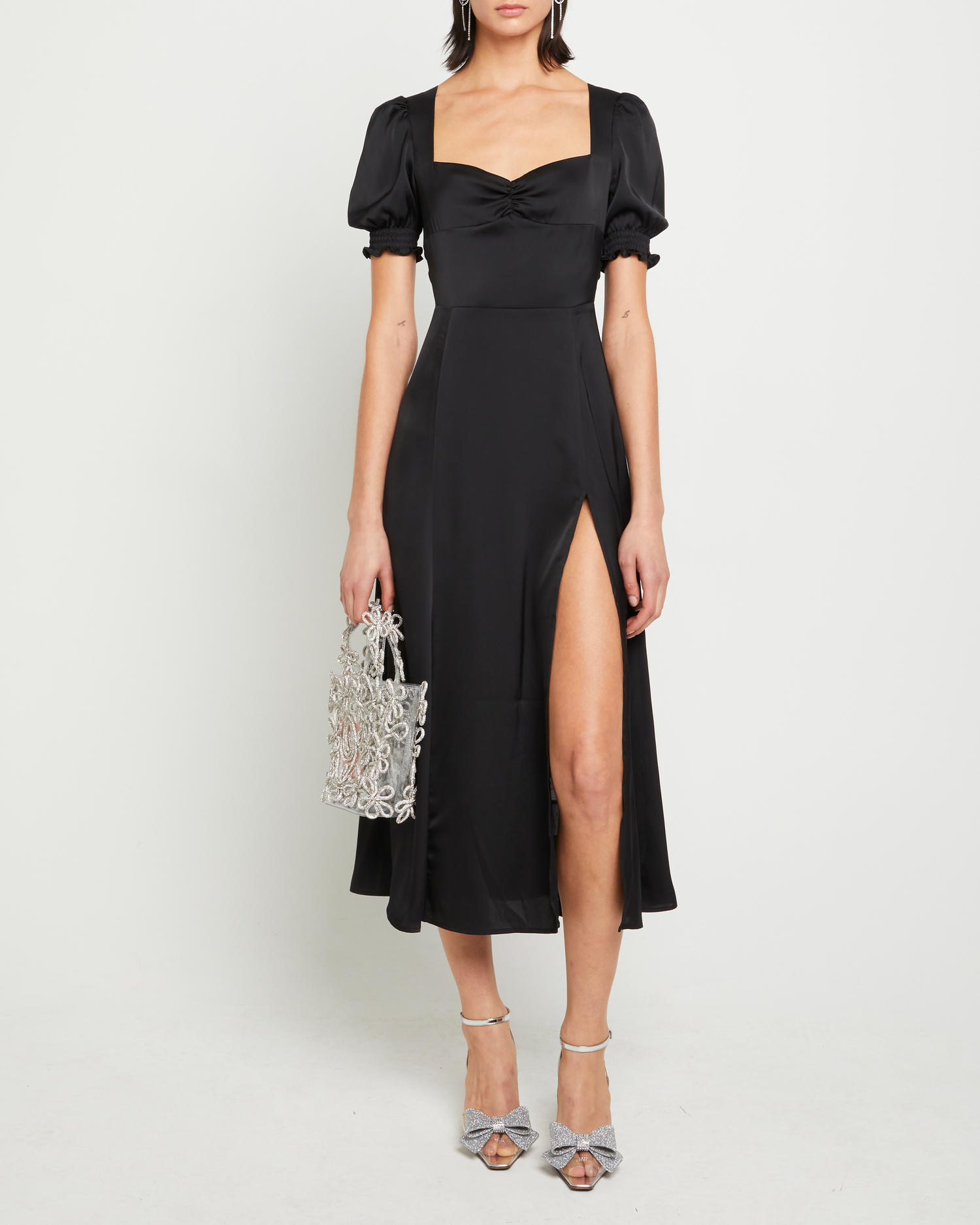 First image of Melanie Dress, a black midi dress, side slit, silky, puff sleeve, cap sleeve, sweetheart neckline