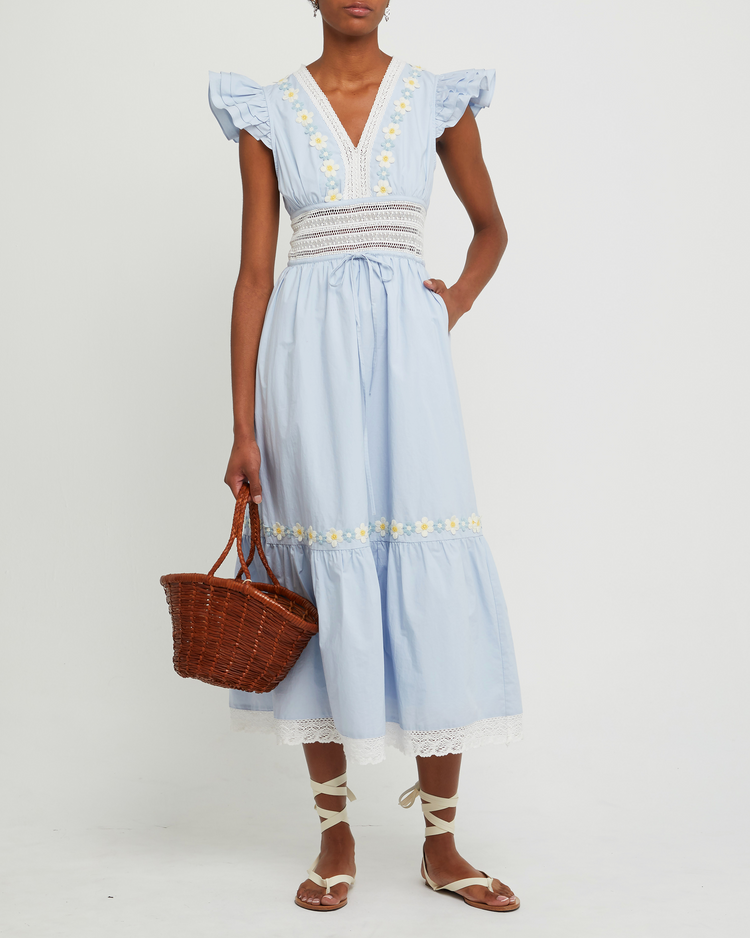 First image of Holly Cotton Dress, a blue midi dress, lace detail, floral embroidered, pocket, sheer, V-neck