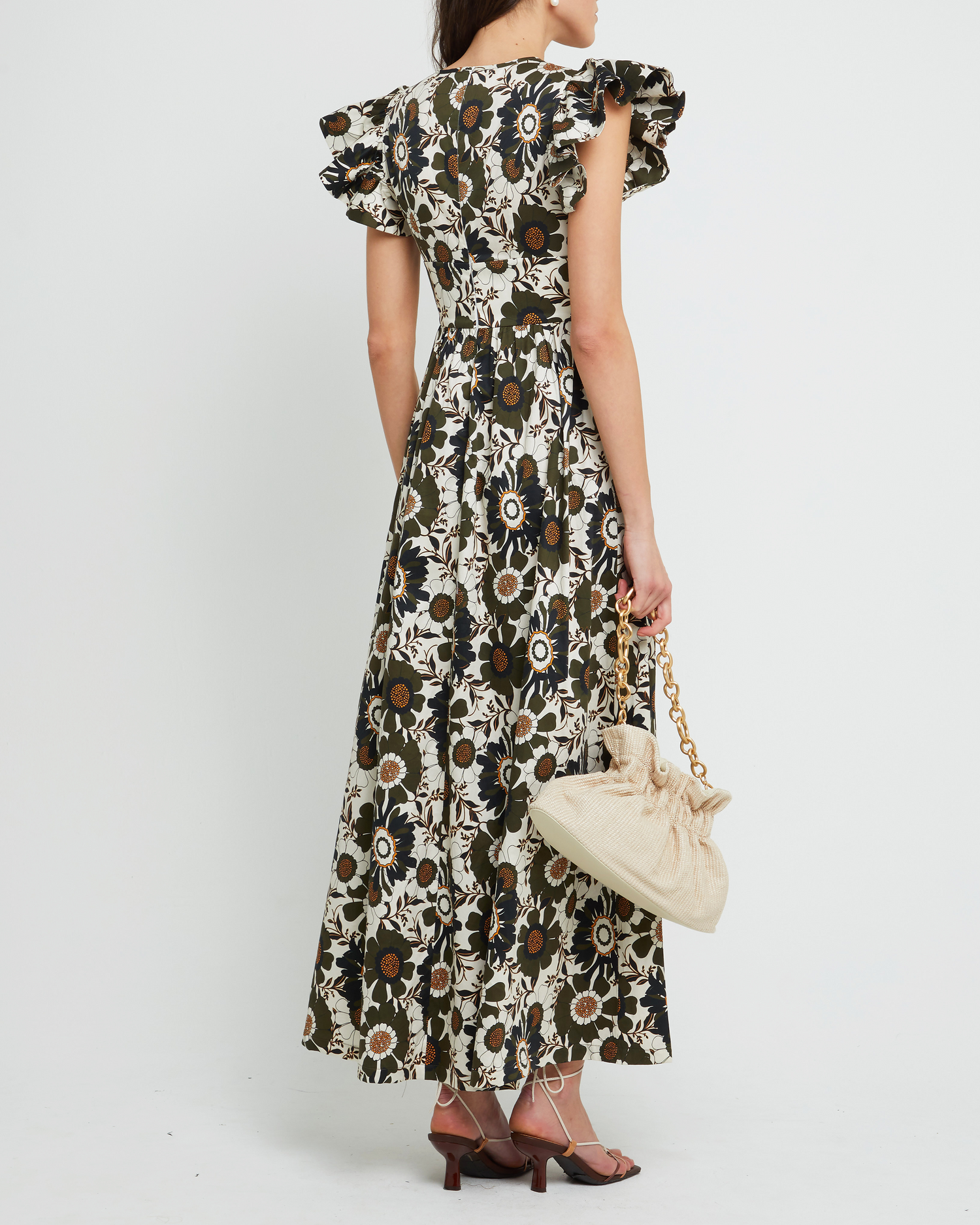 Second image of Martinelli Dress, a white maxi dress, ruffle cap sleeves, pockets, floral print, bold, high neck