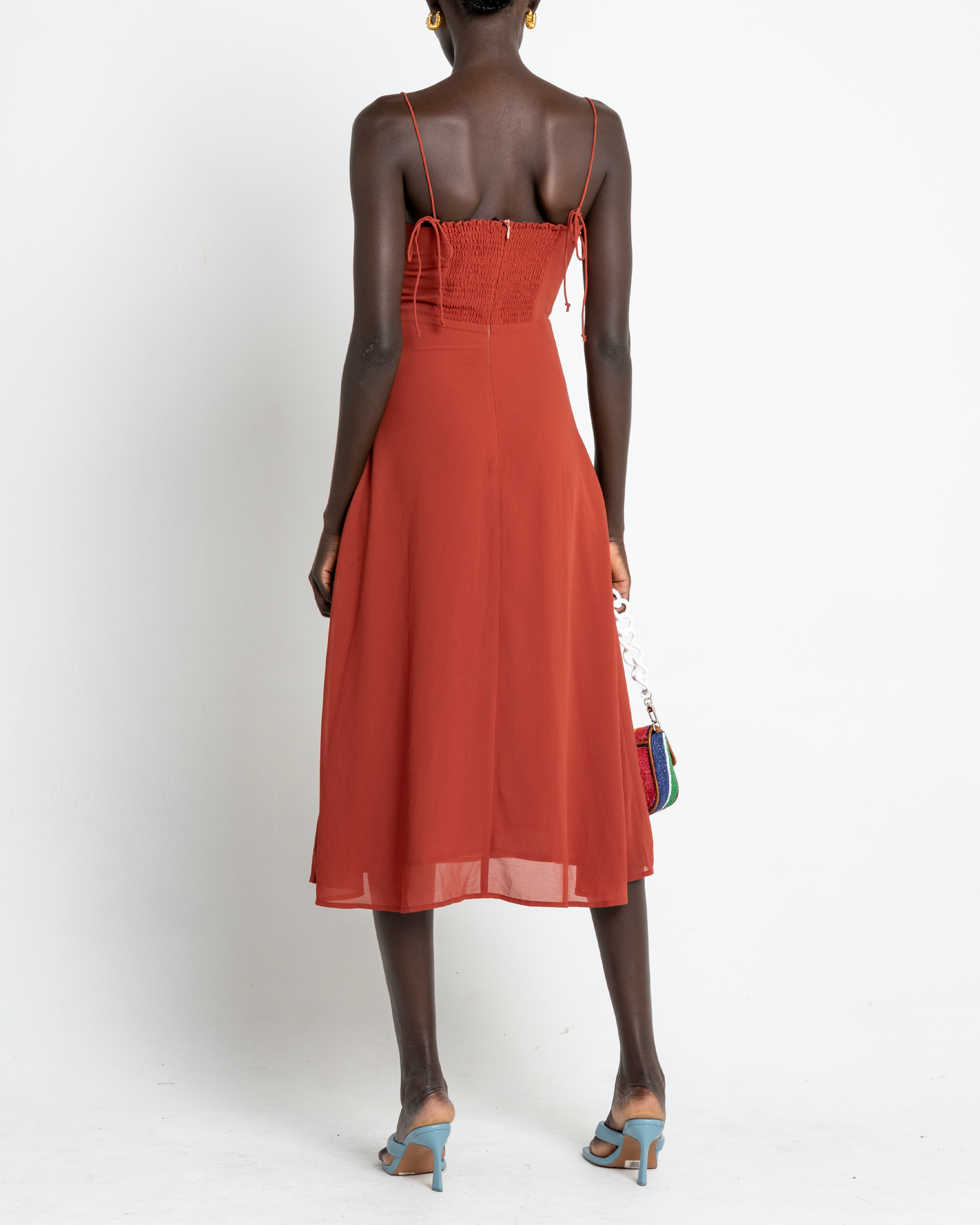 Second image of Venus Dress, a orange midi dress, tie straps, spaghetti straps, side slit, bodice