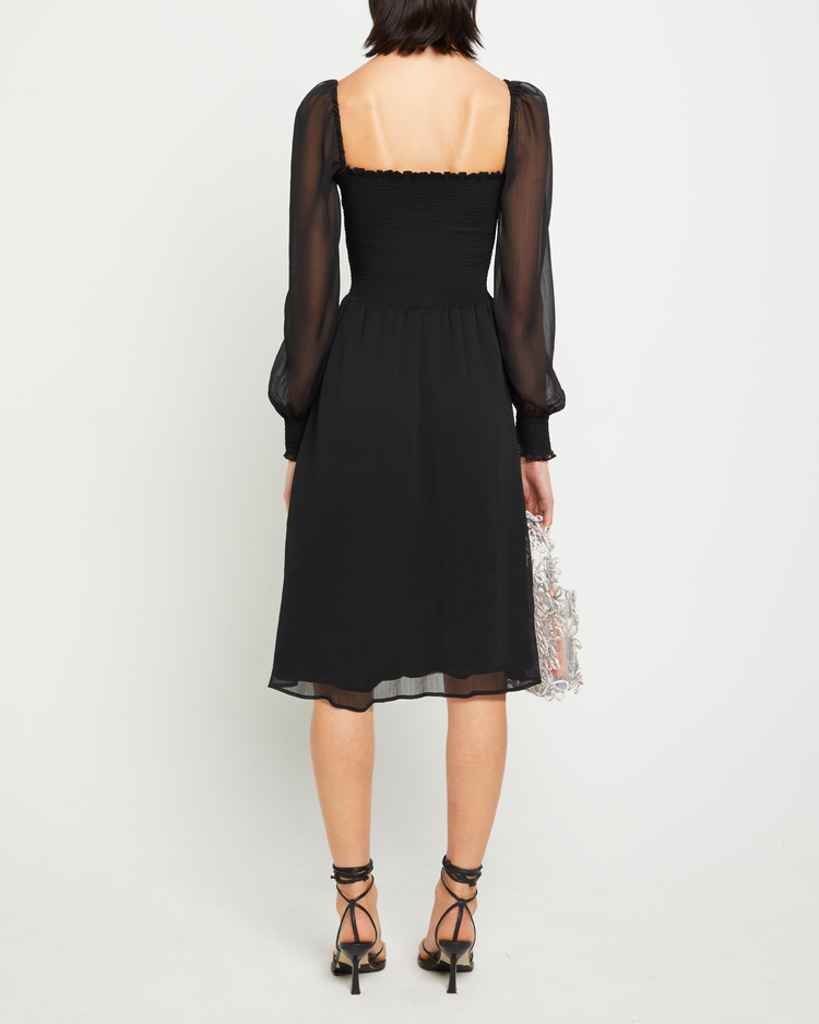 Second image of Classic Smocked Midi Dress, a black midi dress, side slit, long, sheer sleeves, puff sleeves, square neckline, smocked bodice